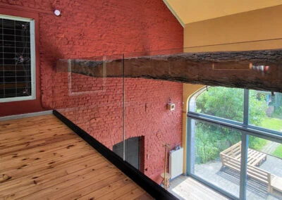 Glazen balustrade op bestaande houten balk in Linter